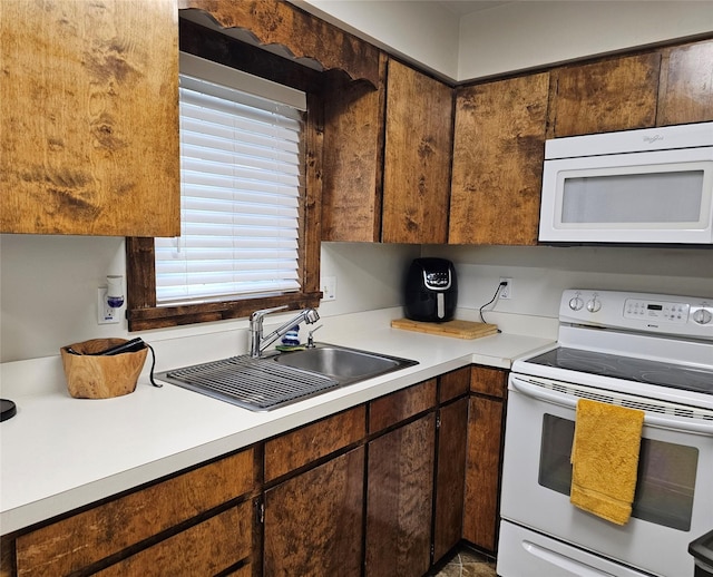 308 Dakota Ave, Libby, MT 59923 - kitchen featuring white appliances, light countertops, and a sink