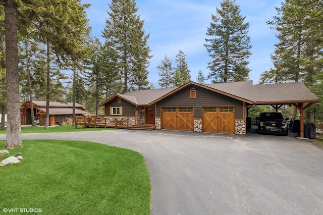 chalet / cabin featuring a garage, a front yard, driveway, stone siding, and a wooden deck