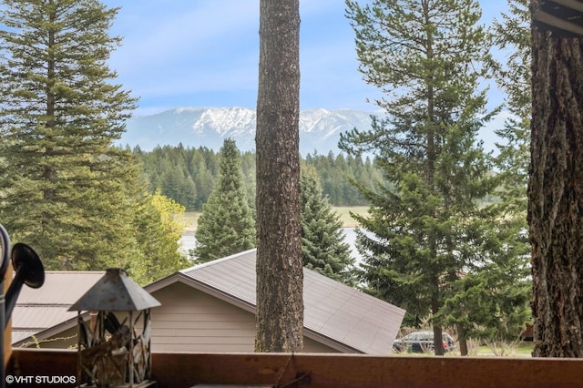 view of mountain background with a heavily wooded area
