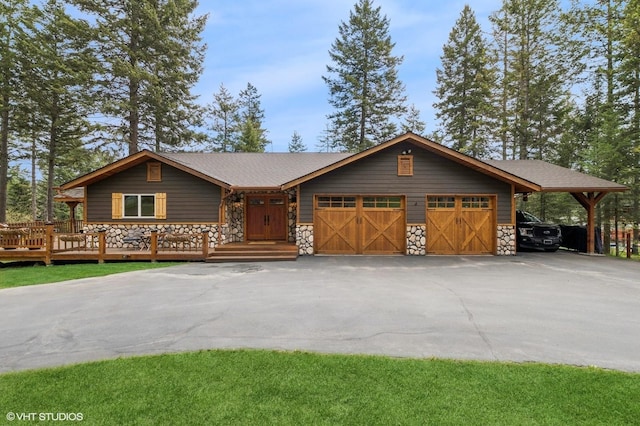rustic home with stone siding, asphalt driveway, and a garage