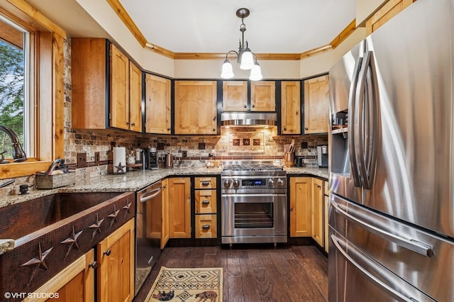 kitchen with appliances with stainless steel finishes, light stone counters, ornamental molding, decorative backsplash, and dark wood-type flooring