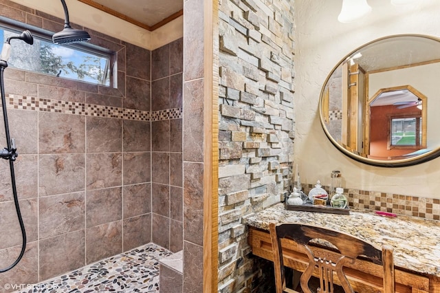 full bath with tiled shower and ornamental molding