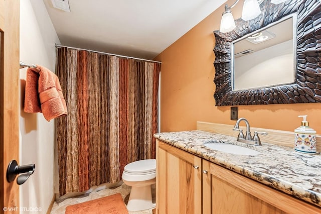 full bathroom featuring toilet, vanity, tile patterned floors, and a shower with shower curtain