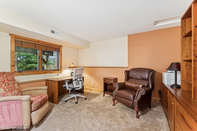 office space featuring light carpet and baseboards