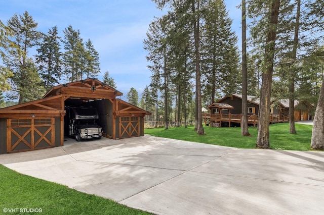view of patio / terrace with concrete driveway and a carport