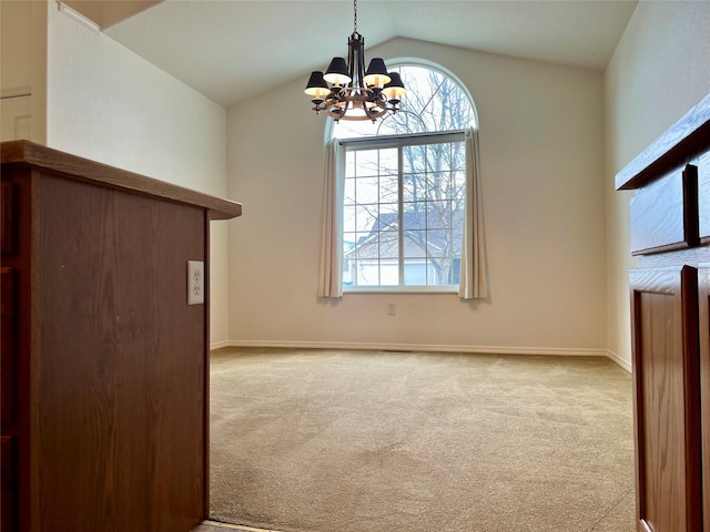 unfurnished living room with baseboards, carpet floors, lofted ceiling, and a chandelier