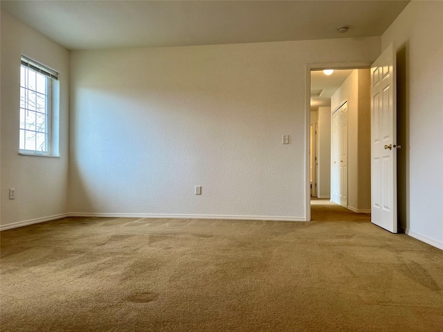 empty room with carpet and baseboards