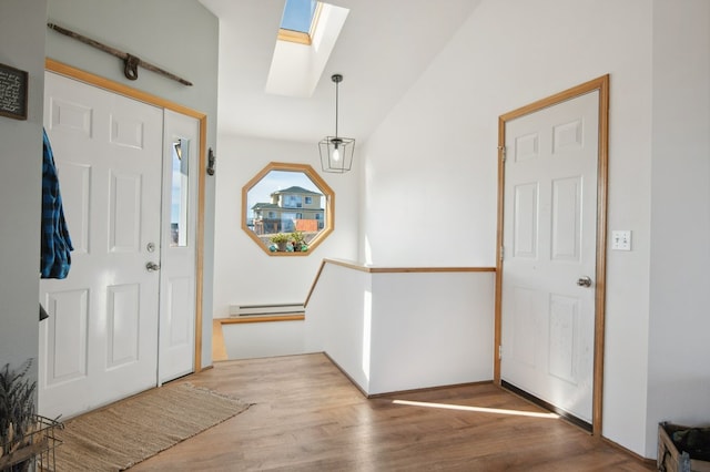 18 Mission View Dr, Polson, MT 59860 - foyer entrance with a skylight, a baseboard radiator, wood finished floors, and vaulted ceiling