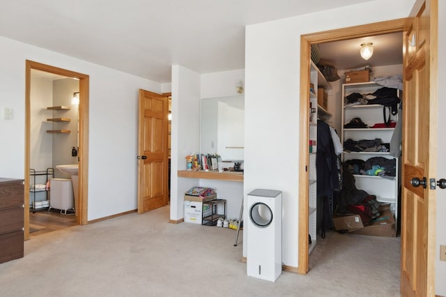 18 Mission View Dr, Polson, MT 59860 - carpeted bedroom with a walk in closet, a closet, ensuite bathroom, and baseboards