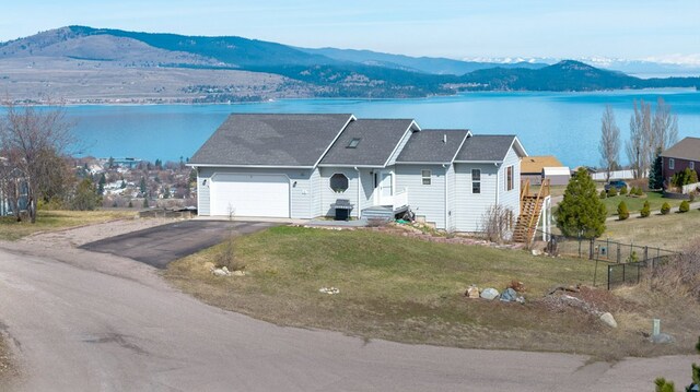 18 Mission View Dr, Polson, MT 59860 - ranch-style house with a garage, a water and mountain view, and asphalt driveway
