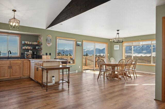 18 Mission View Dr, Polson, MT 59860 - dining room with a chandelier, a baseboard heating unit, wood finished floors, and lofted ceiling