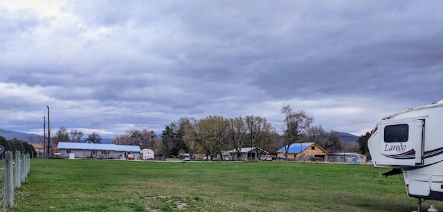 1003 4th Ave, Plains, MT 59859 - view of yard featuring a mountain view and fence