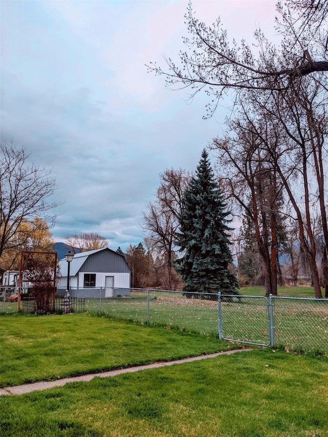 1003 4th Ave, Plains, MT 59859 - view of yard with a detached garage, an outbuilding, and fence