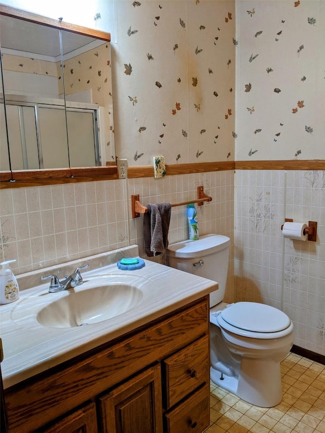 1003 4th Ave, Plains, MT 59859 - full bath with tile patterned floors, toilet, wallpapered walls, a shower stall, and vanity