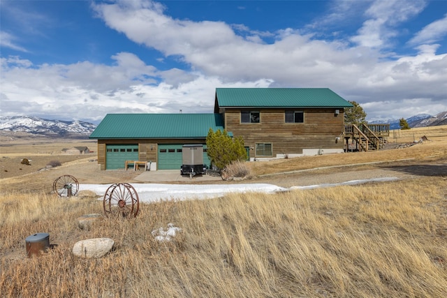 37 Bridger Meadow Ln, Pray, MT 59065 - view of building exterior with driveway, a garage, and a mountain view