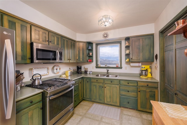 37 Bridger Meadow Ln, Pray, MT 59065 - kitchen with open shelves, appliances with stainless steel finishes, and green cabinetry