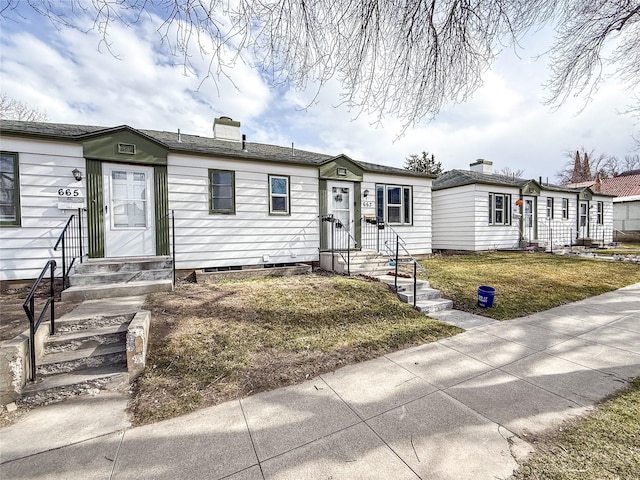 659-665 Logan St, Helena, MT 59601 - view of front facade with a front yard, entry steps, and a chimney