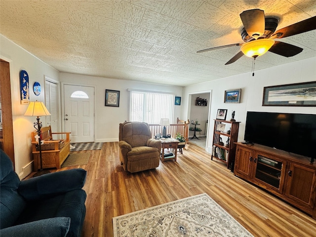 47 3rd Ave S, Stanford, MT 59479 - living area with light wood-style flooring, ceiling fan, and baseboards