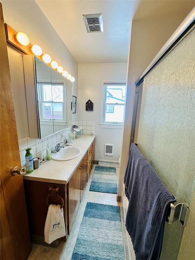 47 3rd Ave S, Stanford, MT 59479 - full bath with vanity, a shower with shower door, and decorative backsplash