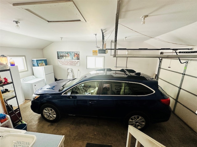 47 3rd Ave S, Stanford, MT 59479 - garage with washing machine and dryer, a garage door opener, and freestanding refrigerator