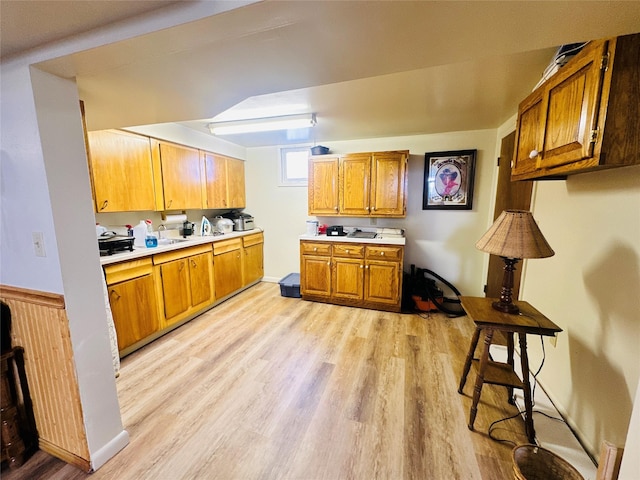 47 3rd Ave S, Stanford, MT 59479 - kitchen featuring light wood-type flooring, brown cabinets, and light countertops