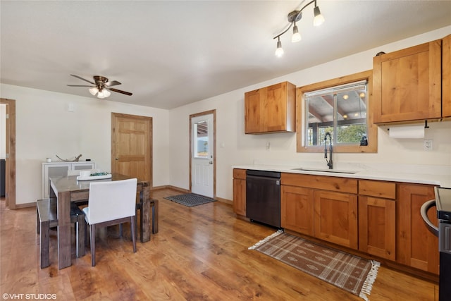 155 Spring Ln, Eureka, MT 59917 - kitchen with light countertops, a sink, dishwasher, light wood-style floors, and ceiling fan
