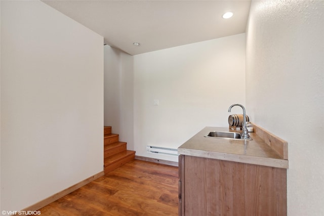 155 Spring Ln, Eureka, MT 59917 - bar featuring light wood-style flooring, recessed lighting, stairway, a sink, and a baseboard heating unit