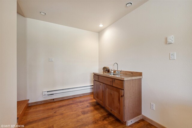 155 Spring Ln, Eureka, MT 59917 - bar featuring a sink, baseboard heating, light wood-style flooring, baseboards, and recessed lighting