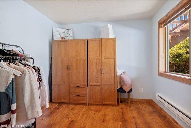 155 Spring Ln, Eureka, MT 59917 - interior space with a baseboard radiator, light wood-type flooring, and baseboards