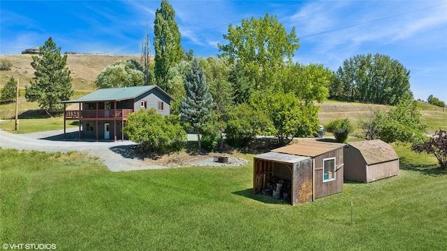 155 Spring Ln, Eureka, MT 59917 - view of yard featuring an outdoor structure, a storage unit, and a wooden deck