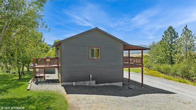 155 Spring Ln, Eureka, MT 59917 - view of property exterior featuring a lawn, stairway, and a deck