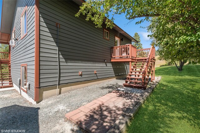 155 Spring Ln, Eureka, MT 59917 - view of side of property with a yard, a deck, and stairs