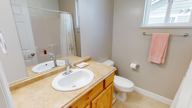 bathroom featuring vanity, toilet, baseboards, tile patterned floors, and curtained shower