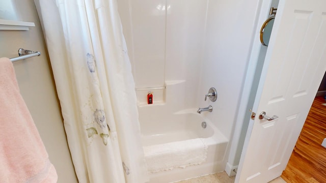 bathroom featuring shower / tub combo and wood finished floors