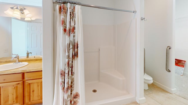 bathroom with a shower stall, toilet, tile patterned flooring, and vanity