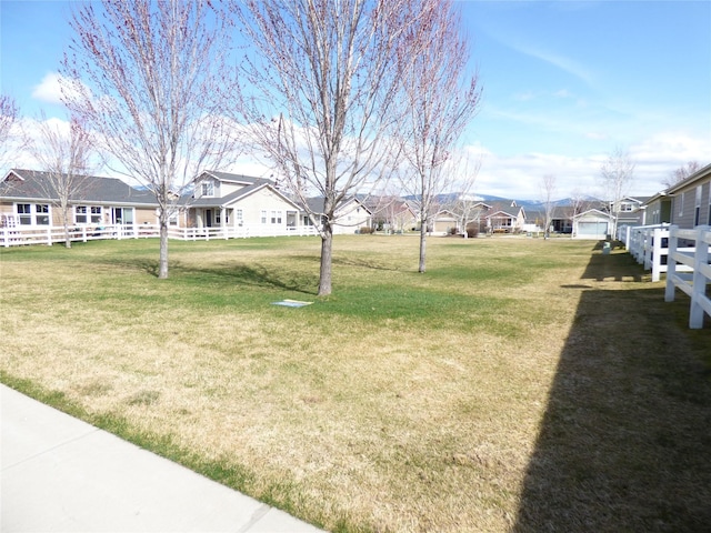 view of yard with a residential view and fence