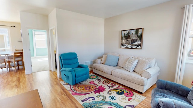 living area featuring visible vents and light wood-style floors