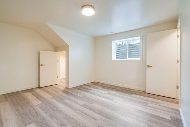 additional living space featuring light wood-style floors and baseboards