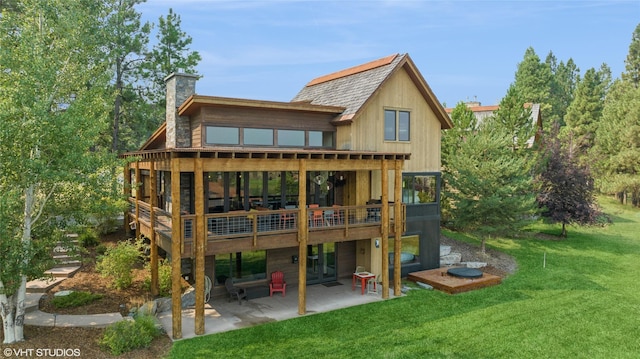62 Wilderness Lodge Rd, Eureka, MT 59917 - rear view of property with a lawn, a chimney, a deck, and a patio area