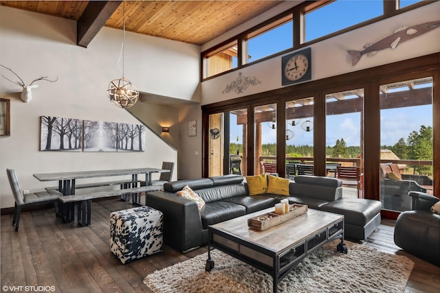 62 Wilderness Lodge Rd, Eureka, MT 59917 - living room featuring dark wood-style flooring, wooden ceiling, a towering ceiling, beamed ceiling, and a notable chandelier