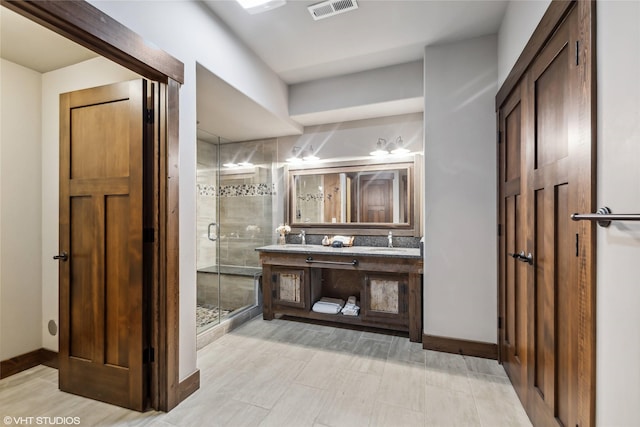 62 Wilderness Lodge Rd, Eureka, MT 59917 - full bathroom featuring baseboards, visible vents, a stall shower, and vanity