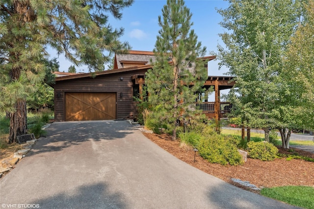 62 Wilderness Lodge Rd, Eureka, MT 59917 - view of front of home featuring a garage and aphalt driveway