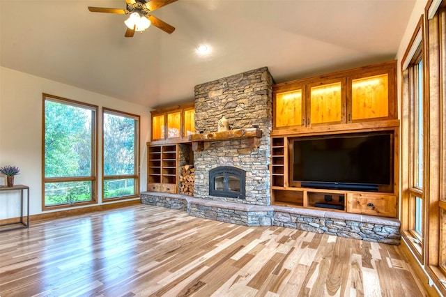 NHN Bears Rd, Stevensville, MT 59870 - unfurnished living room featuring a stone fireplace, baseboards, wood finished floors, and ceiling fan