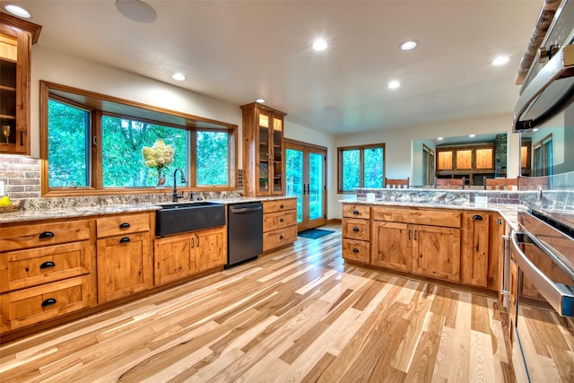 NHN Bears Rd, Stevensville, MT 59870 - kitchen featuring light wood-type flooring, decorative backsplash, a sink, dishwashing machine, and brown cabinetry