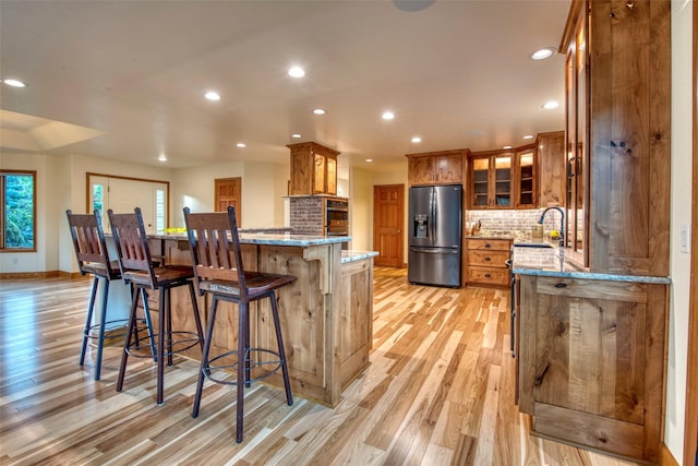 NHN Bears Rd, Stevensville, MT 59870 - kitchen with stainless steel fridge, a sink, light stone counters, and brown cabinets