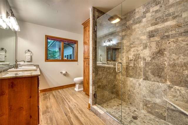 NHN Bears Rd, Stevensville, MT 59870 - bathroom with vanity, toilet, baseboards, a stall shower, and wood finished floors