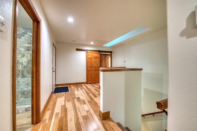 NHN Bears Rd, Stevensville, MT 59870 - hallway featuring baseboards, a barn door, light wood-style floors, and recessed lighting