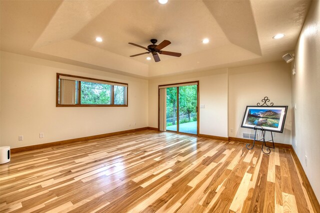 NHN Bears Rd, Stevensville, MT 59870 - unfurnished living room featuring baseboards, a ceiling fan, light wood-style flooring, and a raised ceiling
