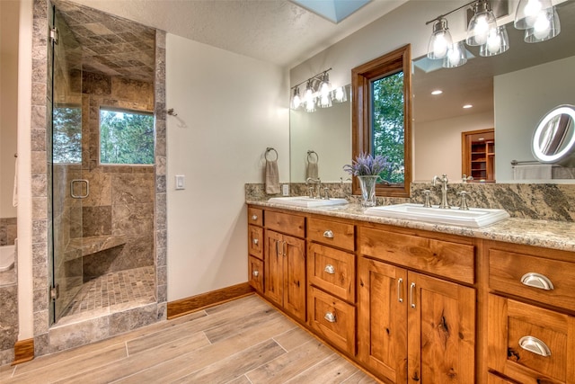 NHN Bears Rd, Stevensville, MT 59870 - bathroom with double vanity, a sink, a shower stall, and wood finished floors