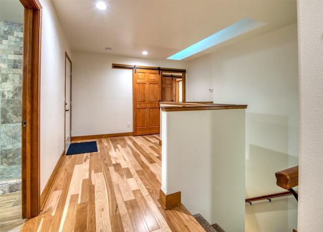 NHN Bears Rd, Stevensville, MT 59870 - hallway with light wood-style flooring, baseboards, a barn door, and recessed lighting